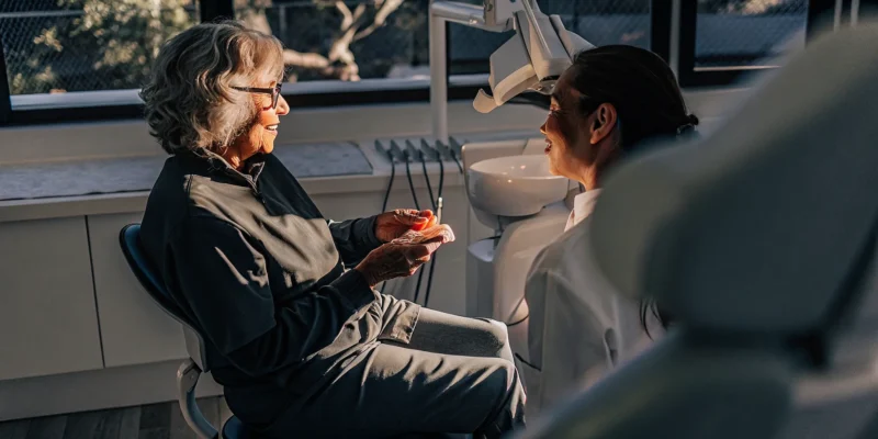 Dentist discussing implant supported dentures with a San Diego patient
