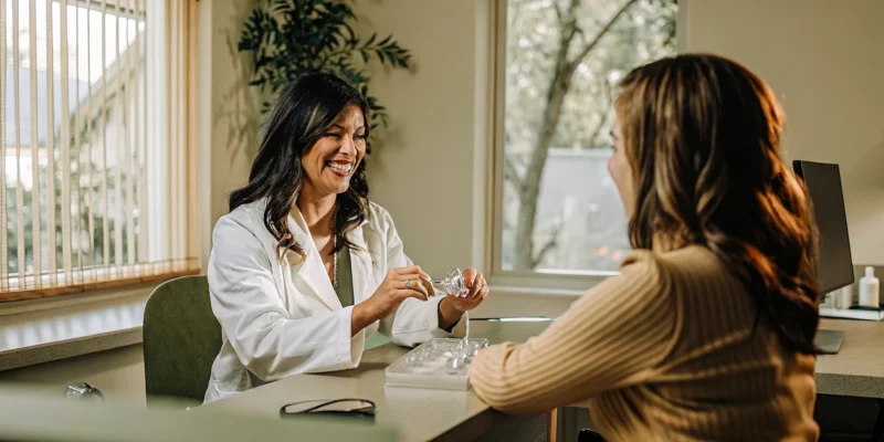 Dentist discussing Invisalign cost in San Diego with a patient