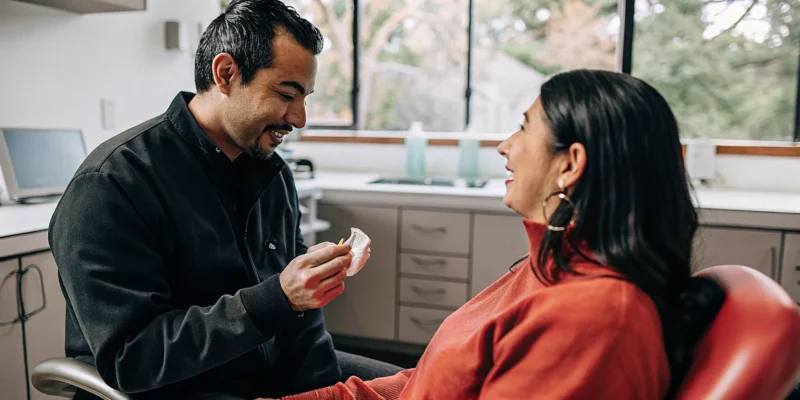 Dentist discussing a custom oral sleep appliance with a patient