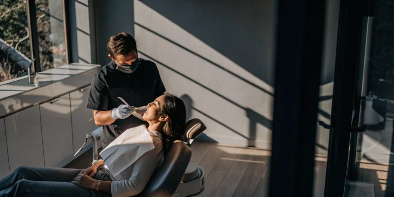 Dentist discussing porcelain veneers and teeth whitening with a patient