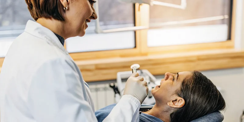 Dentist explaining a custom sleep apnea mouthpiece to a patient