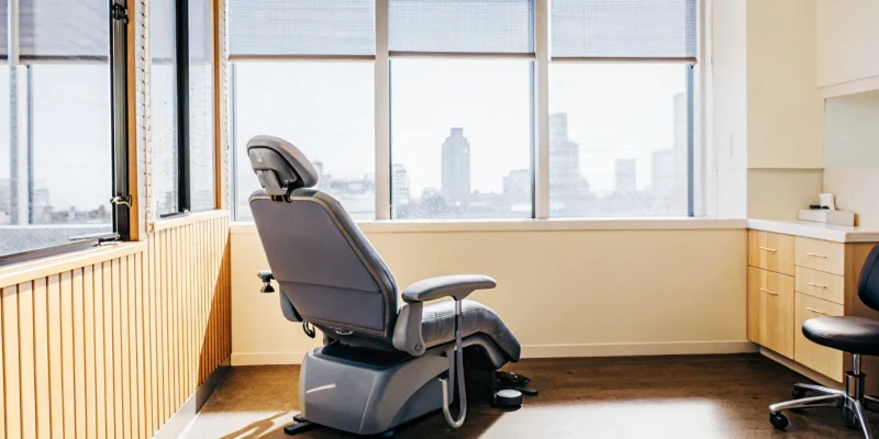 Modern dental office interior in Downtown San Diego with comfortable treatment chair and warm lighting