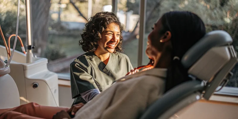 Dentist speaking reassuringly with a relaxed patient in a modern San Diego dental clinic